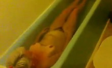 Mature Woman Laying In The Bath Tub