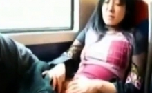 Asian milf rubs her clit on a train.